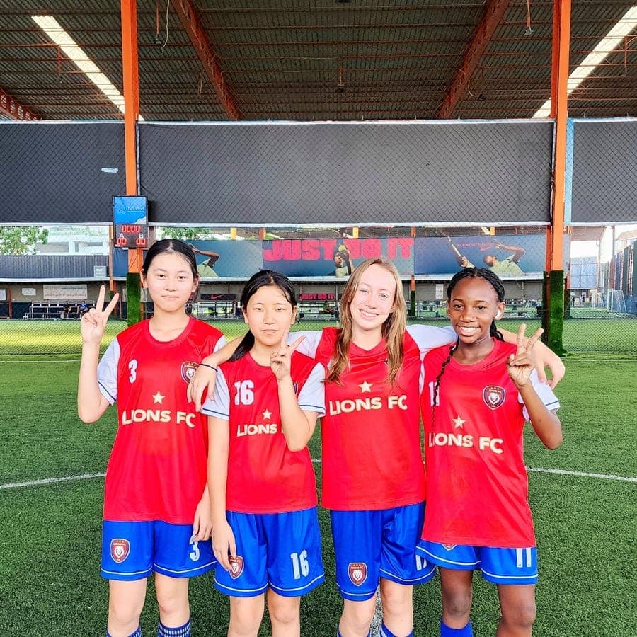 Four players standing together in front of the goal after a session