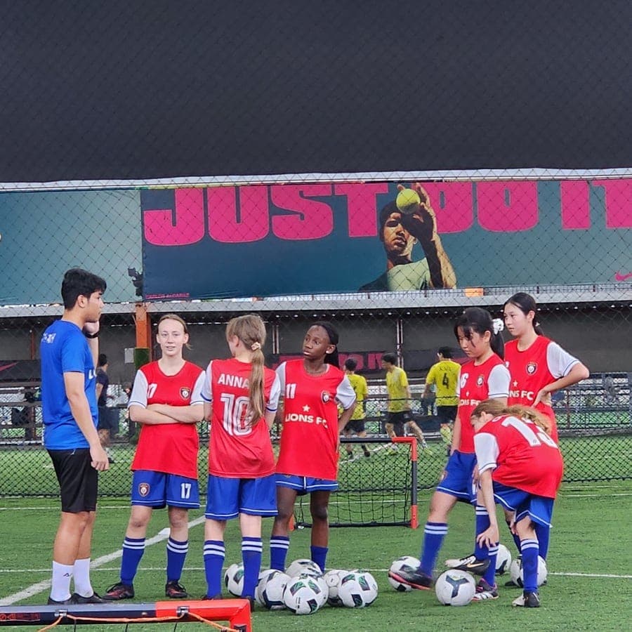 A small-goal game during training, with the group and their coaches